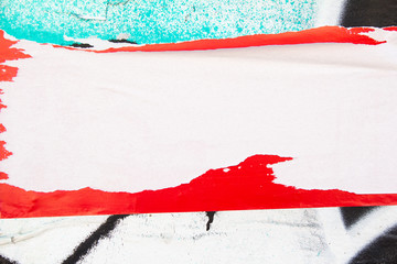 Torn paper placard on dirty urban wall with peeling paint texture background. Copy space for text.