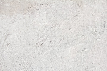 Closeup white blank plaster painted wall with rough grungy surface texture background. Copy space for text.