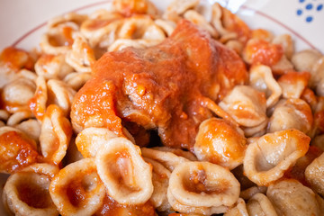 Delicious dish made of fresh pasta orecchietta and meat roll braciola with tomato sauce. Apulia typical food. Italy