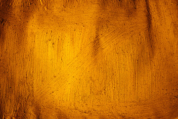 A beautiful Gold paint texture on wall, background - Image. Color paint strokes.