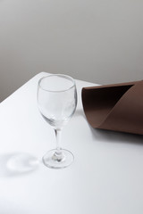 copa transparente de vino vacía sobre fondo gris con intervención en el fondo cafe