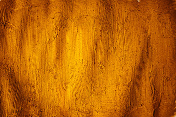 A beautiful Gold paint texture on wall, background - Image. Color paint strokes.
