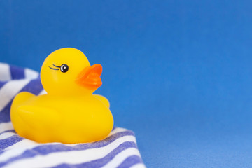 Rubber duck on a blue background minimally creative concept. bathing babies
