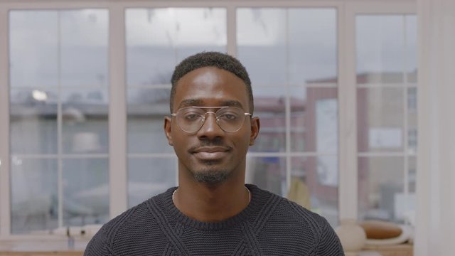 Portrait of handsome African American black mid 20s male smiling and looking into camera. 4K UHD, Shot on ARRI Alexa Mini