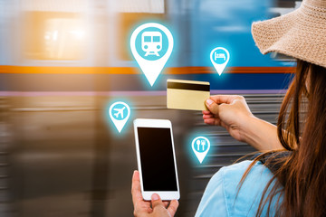 Young smart solo woman tourist travel use mobile phone application plan search information organize trip book reserve transportation bus train hotel flight by internet cashless credit card technology