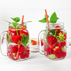 Fresh cool drink of ripe juicy cherry, strawberry, currant and gooseberry berries