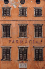 an old and abandoned historic building with wooden windows
