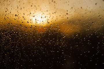 Sunset warm light through the wet window after rain 