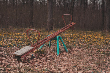 old rusty swings near the forest