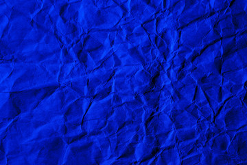 Blue crumpled craft paper texture. Solid background.