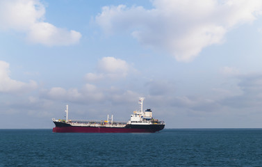 Logistics and transportation of International Container Cargo ship in the ocean at Sunshine sky,...