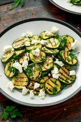 Warm salad with grilled zucchini, garlic and herbs