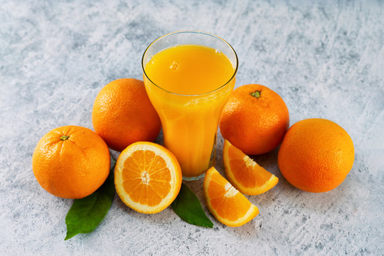 Top view of fresh orange juice, oranges and slices on blue background © Katecat