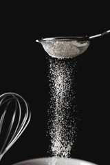 Sifting flour through a sieve