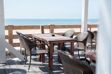Summer terrace cafe with sea view. Tables and chairs on the summer terrace.