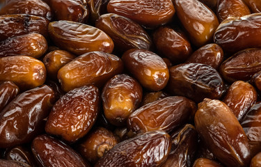 The surface texture of selected dried dates. Natural oriental sweets.