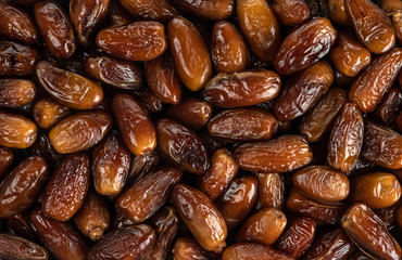 The surface texture of selected dried dates. Natural oriental sweets. Selective focus.