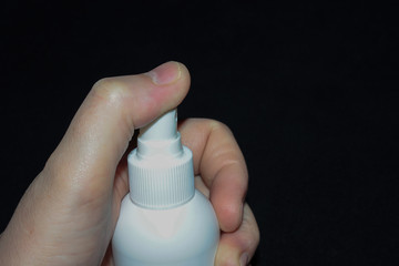 hand holding a can of antiseptic