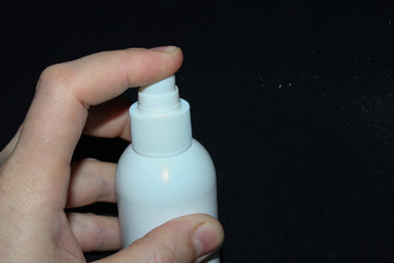 hand holding a can of antiseptic