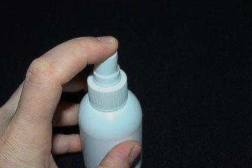 hand holding a can of antiseptic