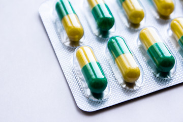 Medical capsules in plastic packaging on a white background