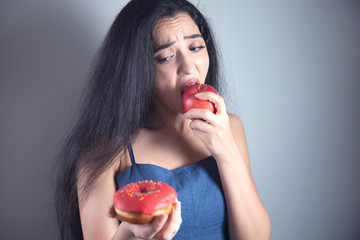 woman hand holding Donut and apple