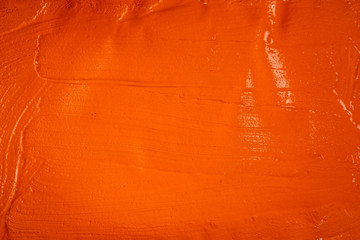 A beautiful Orange paint texture on wall, background - Image. Color paint strokes.