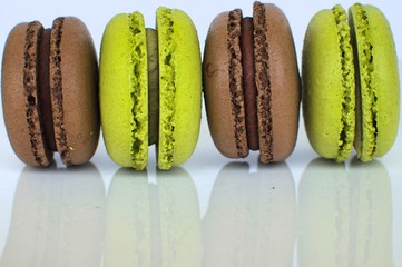 pistachio and chocolate flavor macarooon on white background