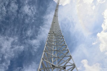 Steel tower set against cloudy blue sky