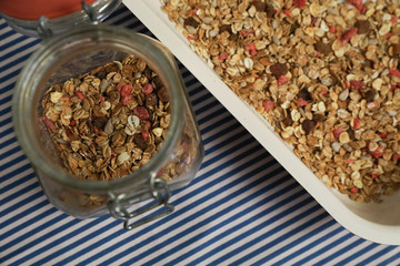 Granola, homemade muesli in a jar and on a plate. Vertical and horizontal photos