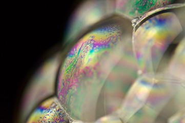 Soap bubbles with rainbow reflected in macro view