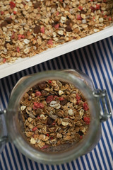 Granola, homemade muesli in a jar and on a plate. Vertical and horizontal photos