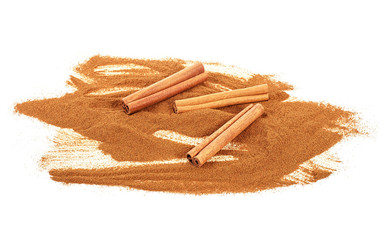 Ground cinnamon and cinnamon sticks isolated on a white background