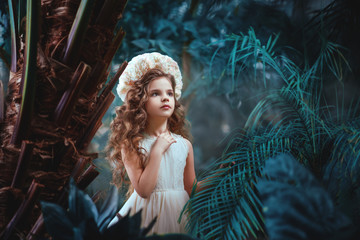 Cute dreaming little girl with flower wreath. She looks up. Photo with artistic tones. Fairytale Photography