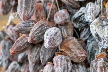Dried persimmon berries. Large, ripened vegetables. Selling a crop in the market. Natural, healthy, vitamin-rich foods. Food for health.