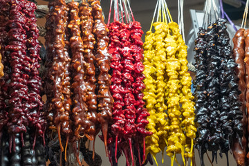 National Georgian Sweet Churchkhela. Composed of nuts and natural grape syrup. Selling crops on the market. Natural, healthy, vitamin-rich foods. Food for health.