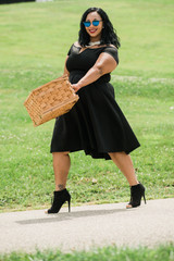 African-American woman walking with picnic basket
