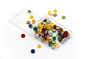 Thumb tacks scattered on white surface #1