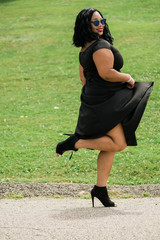 African-American woman in black dress with sunglasses