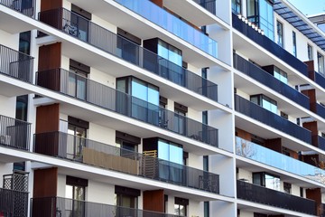 Contemporary residential building exterior in the daylight. Modern apartment buildings on a sunny day with a blue sky. Facade of a modern apartment building