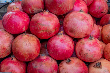 Red pomegranate in a box. Selling crops on the market. Natural, healthy, vitamin-rich foods. Food for health.