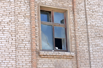 Fototapeta na wymiar broken window in the brick wall of an old building.