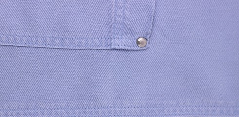 Denim jeans texture.Denim background texture for design.Canvas denim texture.Blue denim that can be used as background.Light blue jeans detail with seams and rivet, casual blue jeans close up.Banner