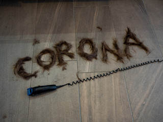 Corona lettering made of hair to illustrate the upcoming problems of hairdressers