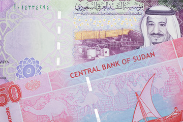 A five Saudi Arabian bill with a fifty pound note from Sudan close up in macro