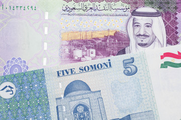 A close up image of a five riyal note from Saudi Arabia along with a five somoni note from Tajikistan