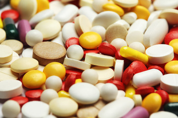 Different colorful tablets at white background	