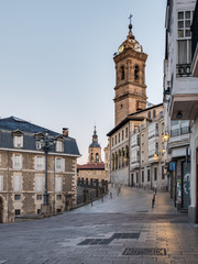 View of the tower of St. Vincent Church and Cuesta de San Vicente Street, in the back the tower of...