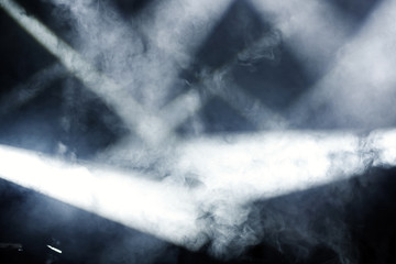 Ray of light with smoke and fog spotlights on the stage. Scene light equipment