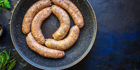 meat sausages,
grilled meat with spices
barbecue raw preparation,
Menu concept food background keto or paleo diet. top view. copy space for text 